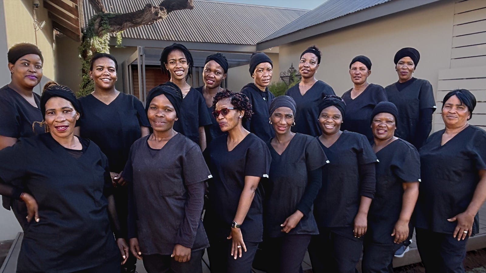 Spotless Cleaning Services staff gathered together in uniform