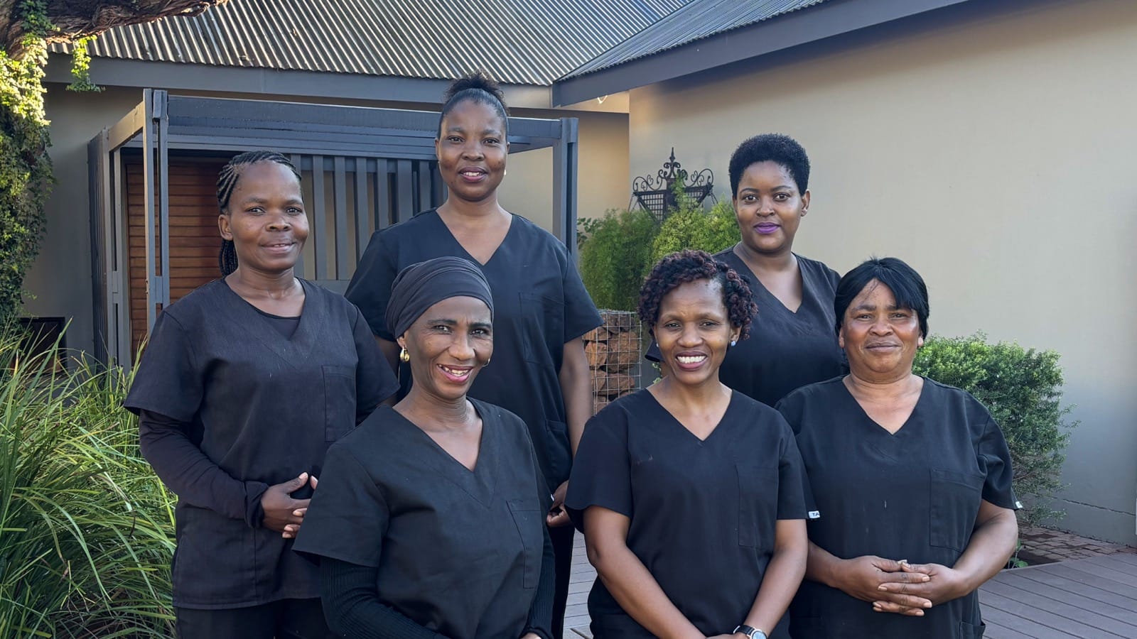 Spotless Cleaning Services team members standing together outdoors